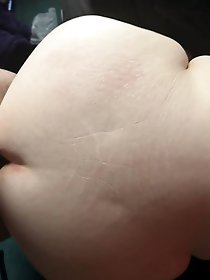 Naked older woman standing on the street