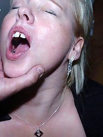 A mature woman in lingerie engages in doggy style position